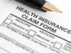 Blank Insurance Claim Form with pen