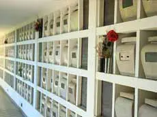 Urns with ashes in a columbarium wall