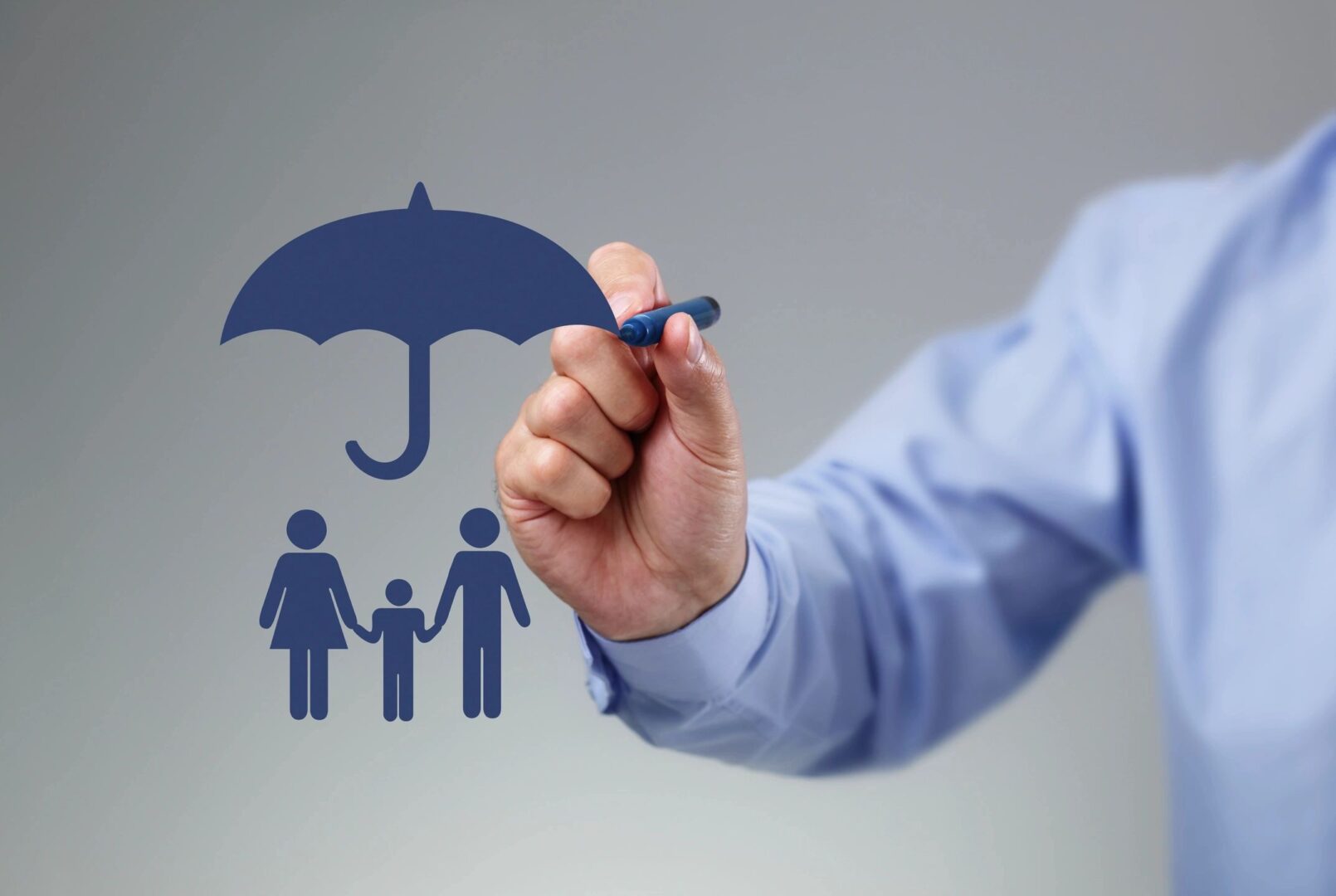 A person drawing an umbrella over their family.